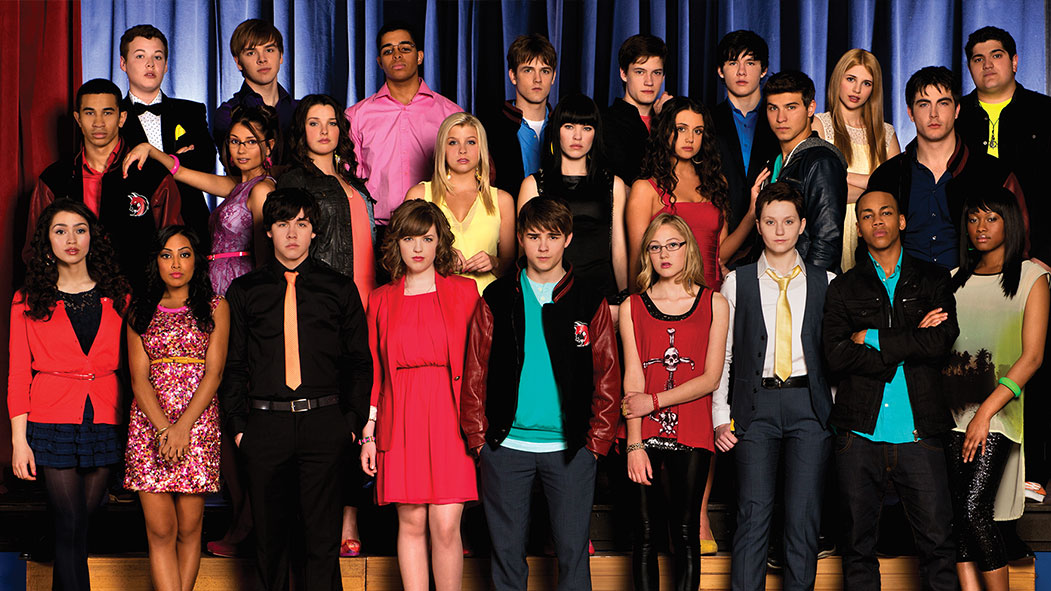 A group of high school students standing on a stage posing for a picture. 